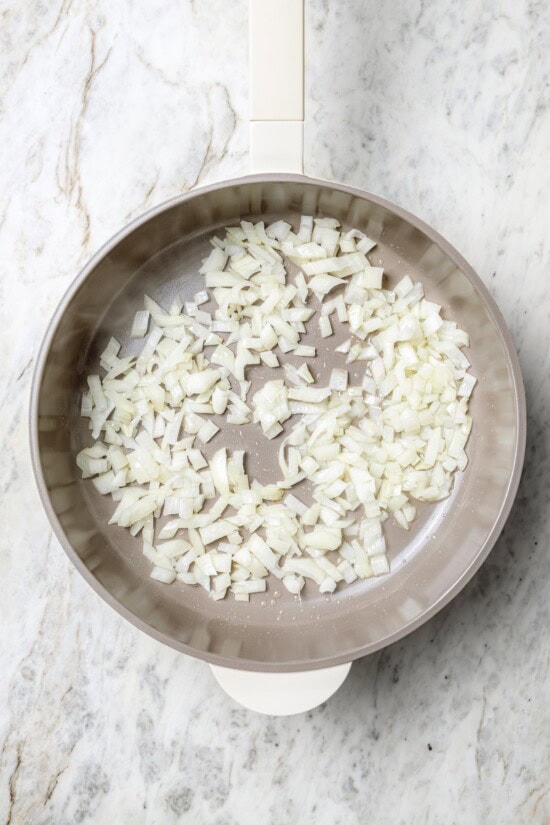 Overhead view of onion in skillet