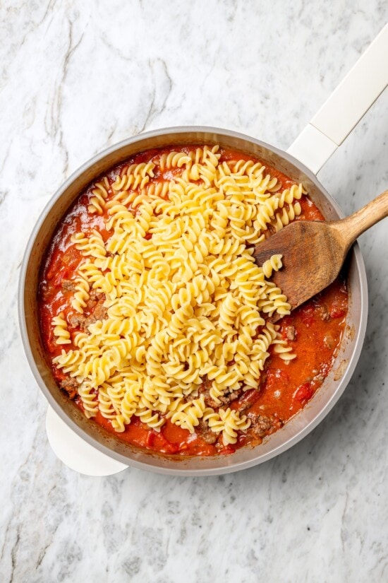 Overhead view of pasta added to ground beef mixture