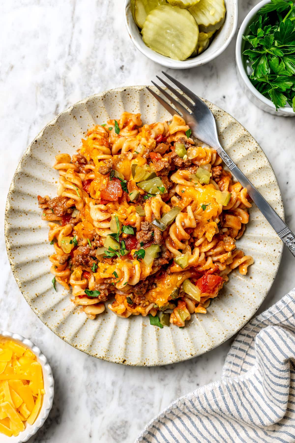 Overhead view of cheeseburger casserole on plate with fork