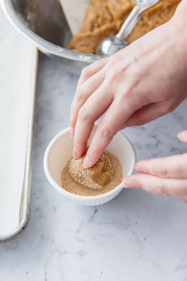 Rolling dough ball in maple sugar.