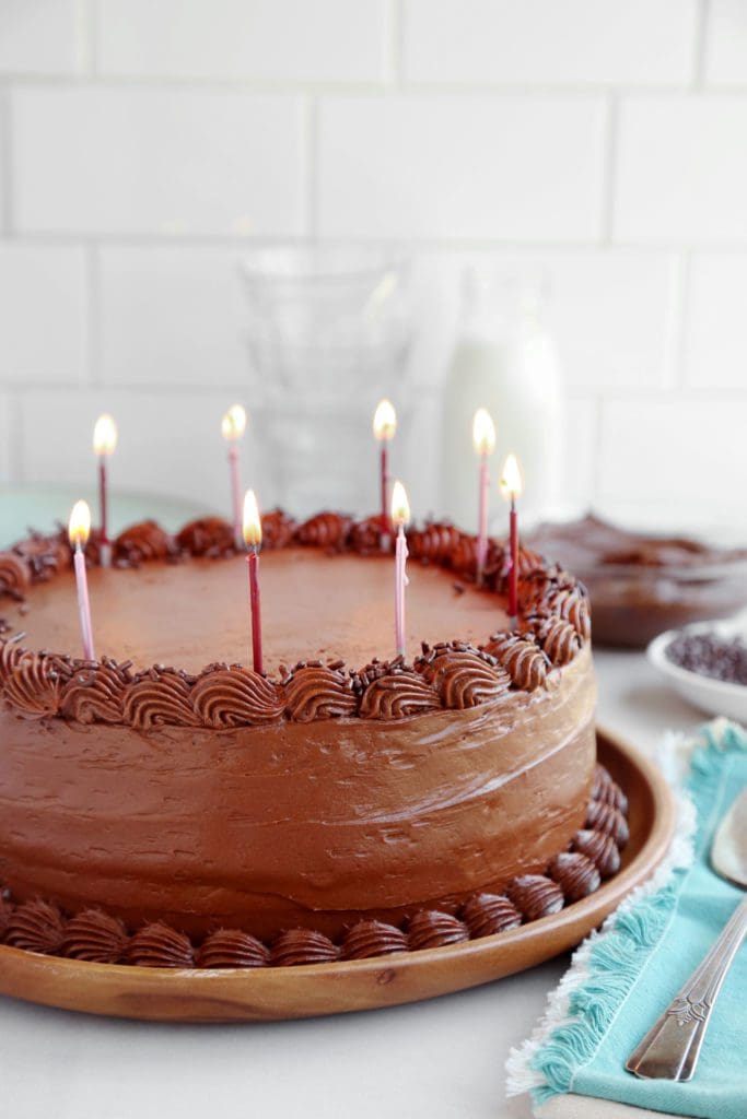Everybody's Birthday Chocolate Cake Recipe a chocolate birthday cake with candles on a marble countertop